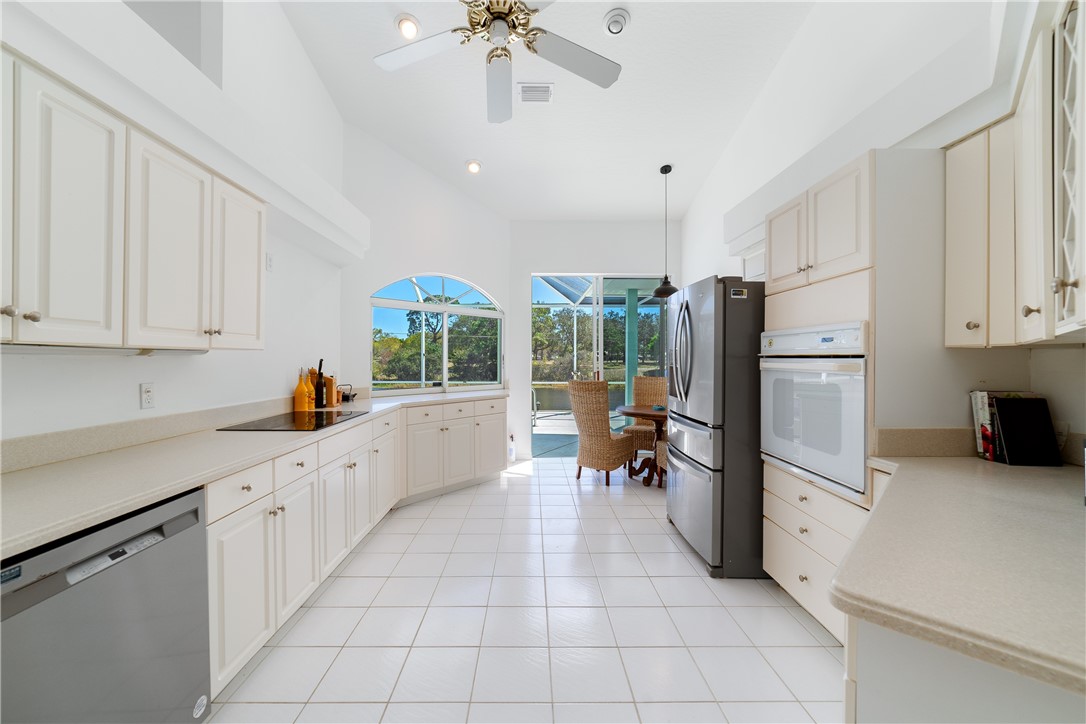 419 Ponoka Street Sebastian, FL 32958 - Photo 10 of 33 a kitchen with white cabinets and white appliances