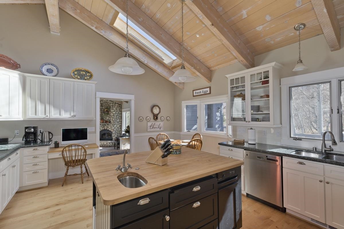 96 Aspen Spring Ranch Road Mammoth Lakes, CA 93546 - Photo 11 of 43 a view of living room with granite countertop furniture a fireplace a flat screen tv and windows