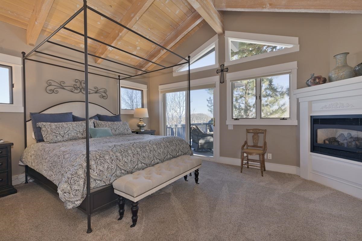 96 Aspen Spring Ranch Road Mammoth Lakes, CA 93546 - Photo 13 of 43 a bedroom with a bed and a fireplace