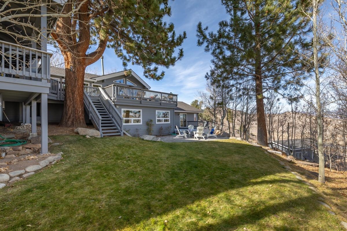 96 Aspen Spring Ranch Road Mammoth Lakes, CA 93546 - Photo 30 of 43 a brick house with a big yard and large trees
