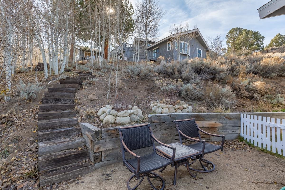 96 Aspen Spring Ranch Road Mammoth Lakes, CA 93546 - Photo 31 of 43 a view of a chairs and table in the back yard