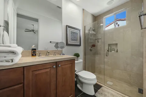 a bathroom with a double vanity sink toilet and shower