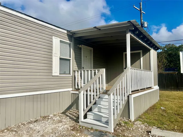 a view of wooden house with a large window