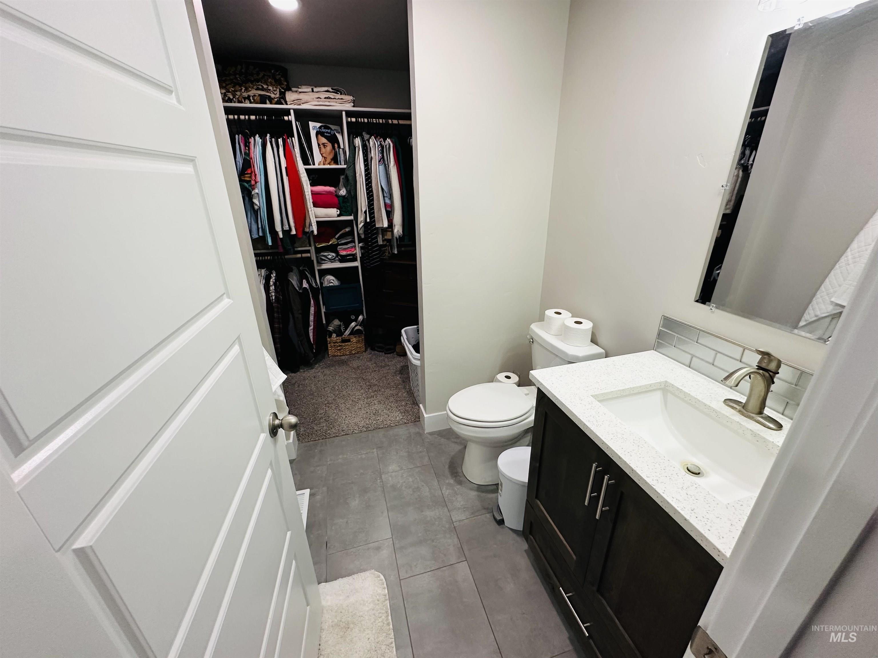 911 Campbell Street Vale, OR 97918 - Photo 13 of 37 Bathroom featuring vanity, light tile patterned floors, and a walk in closet