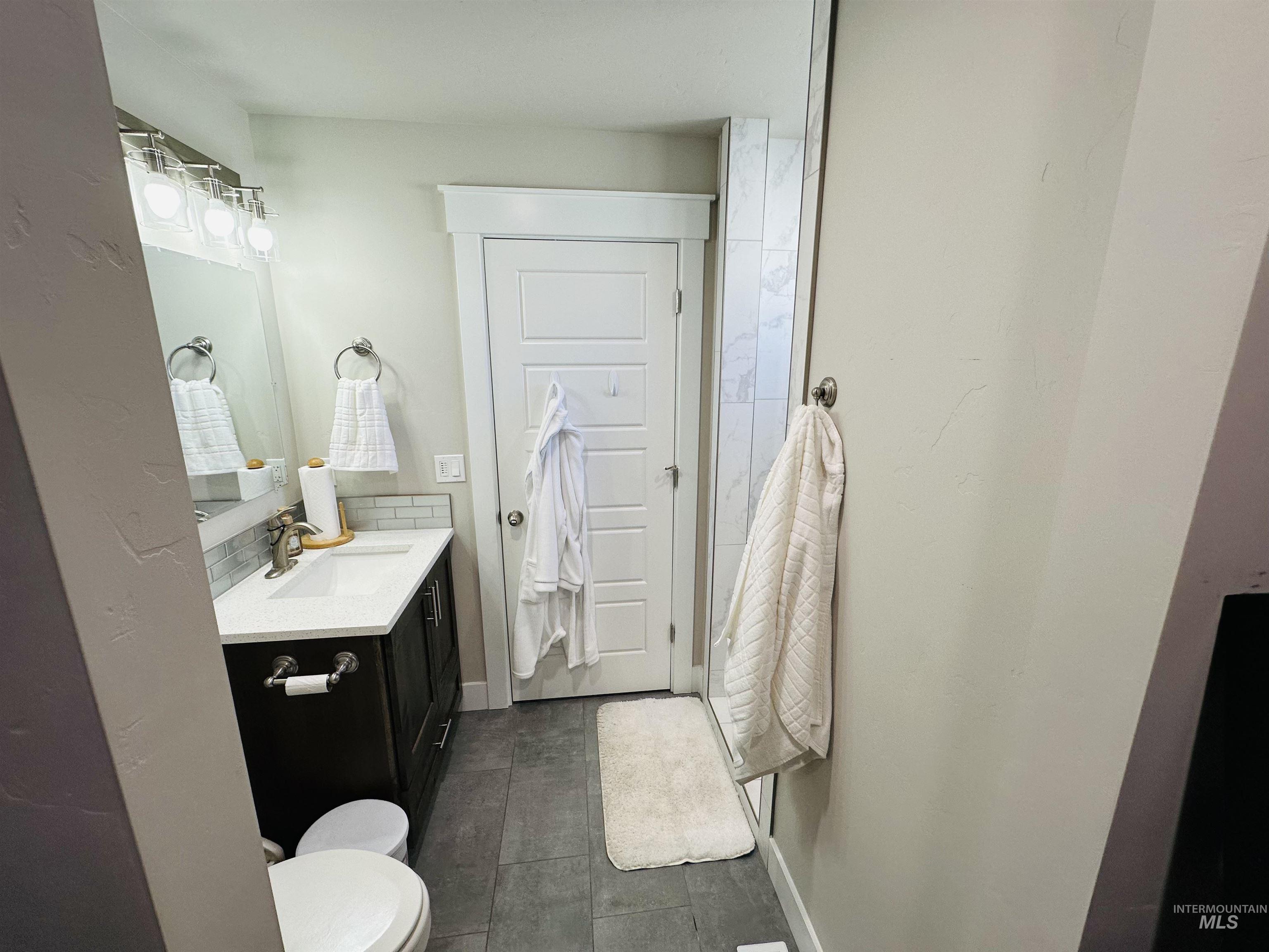 911 Campbell Street Vale, OR 97918 - Photo 14 of 37 Bathroom featuring vanity and dark tile patterned floors