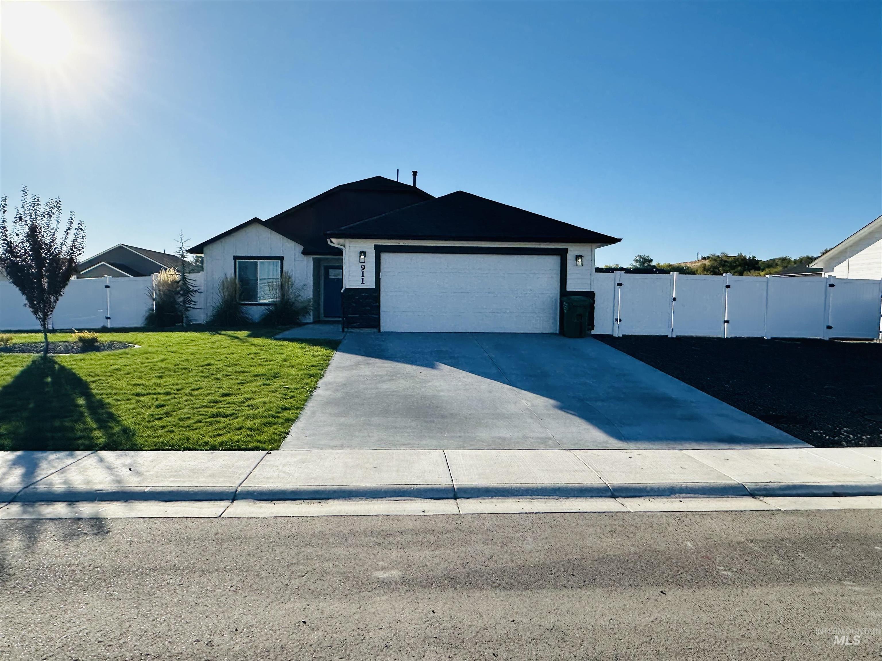 911 Campbell Street Vale, OR 97918 - Photo 2 of 37 Single story home featuring a gate, concrete driveway, and an attached garage