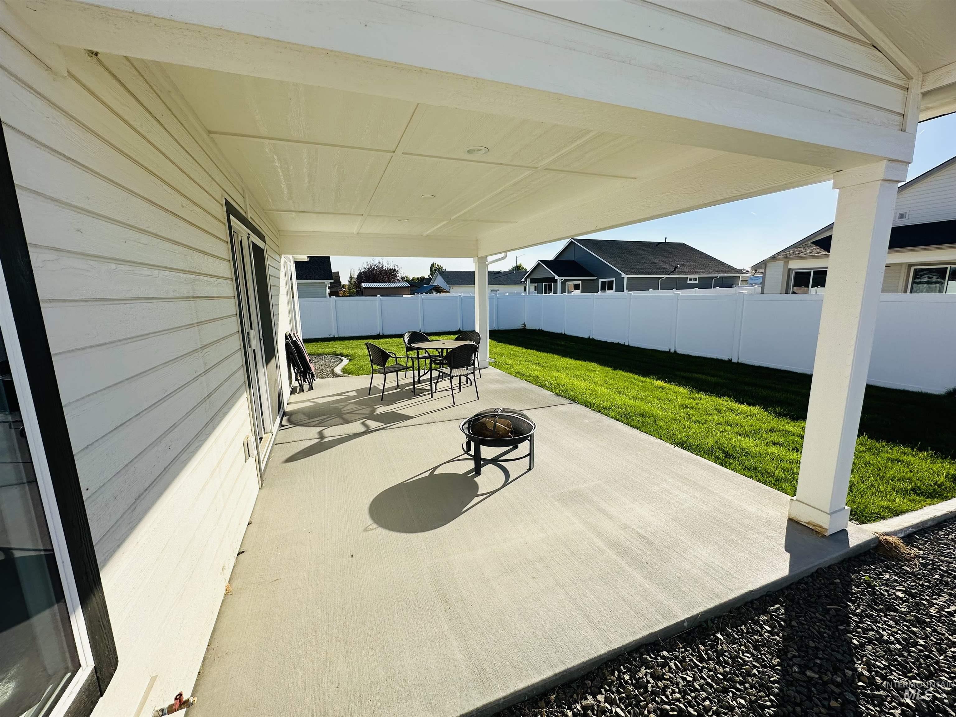 911 Campbell Street Vale, OR 97918 - Photo 25 of 37 Fenced backyard with a patio area and an outdoor fire pit
