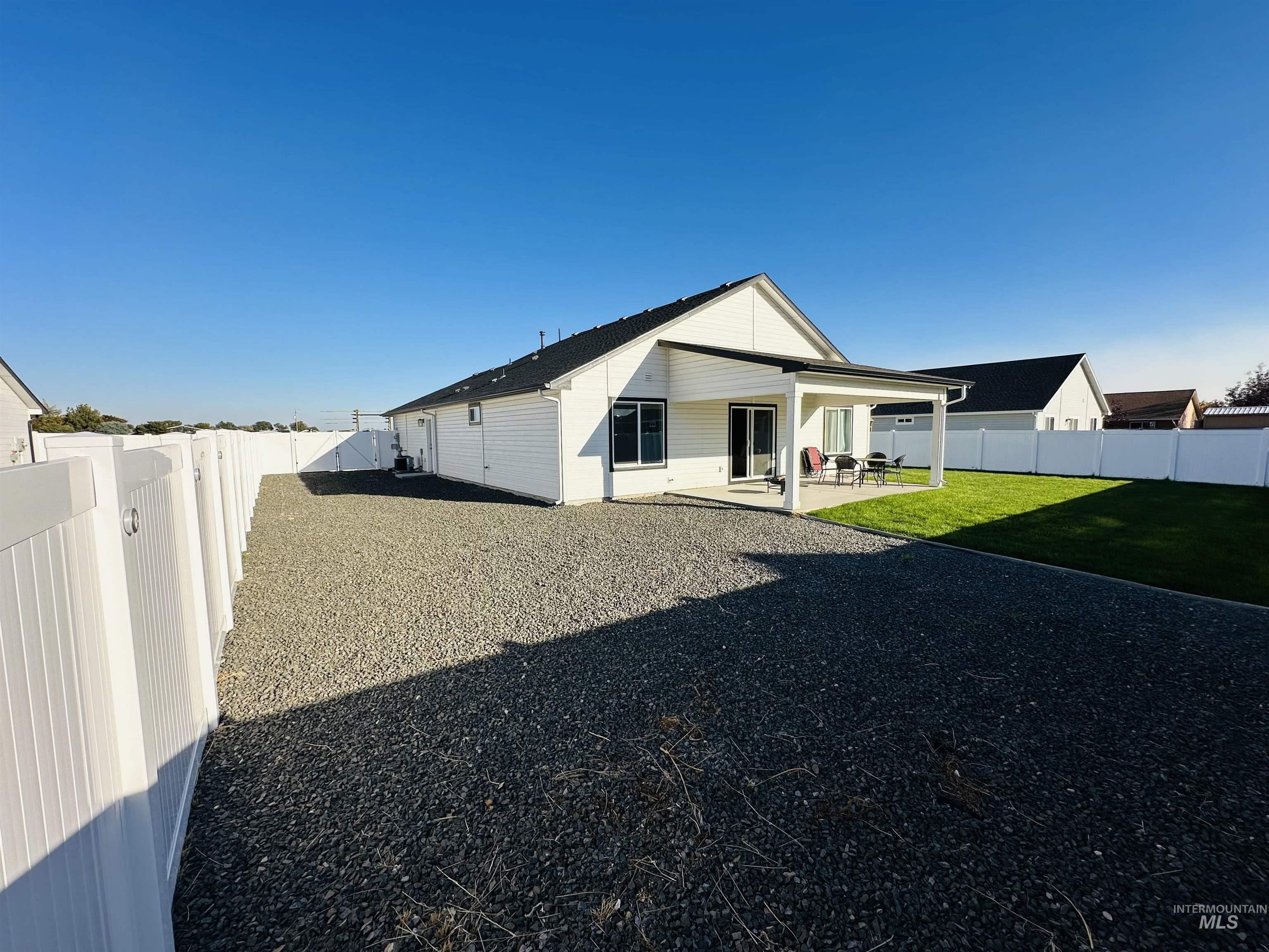 911 Campbell Street Vale, OR 97918 - Photo 28 of 37 Back of house with a fenced backyard and a patio