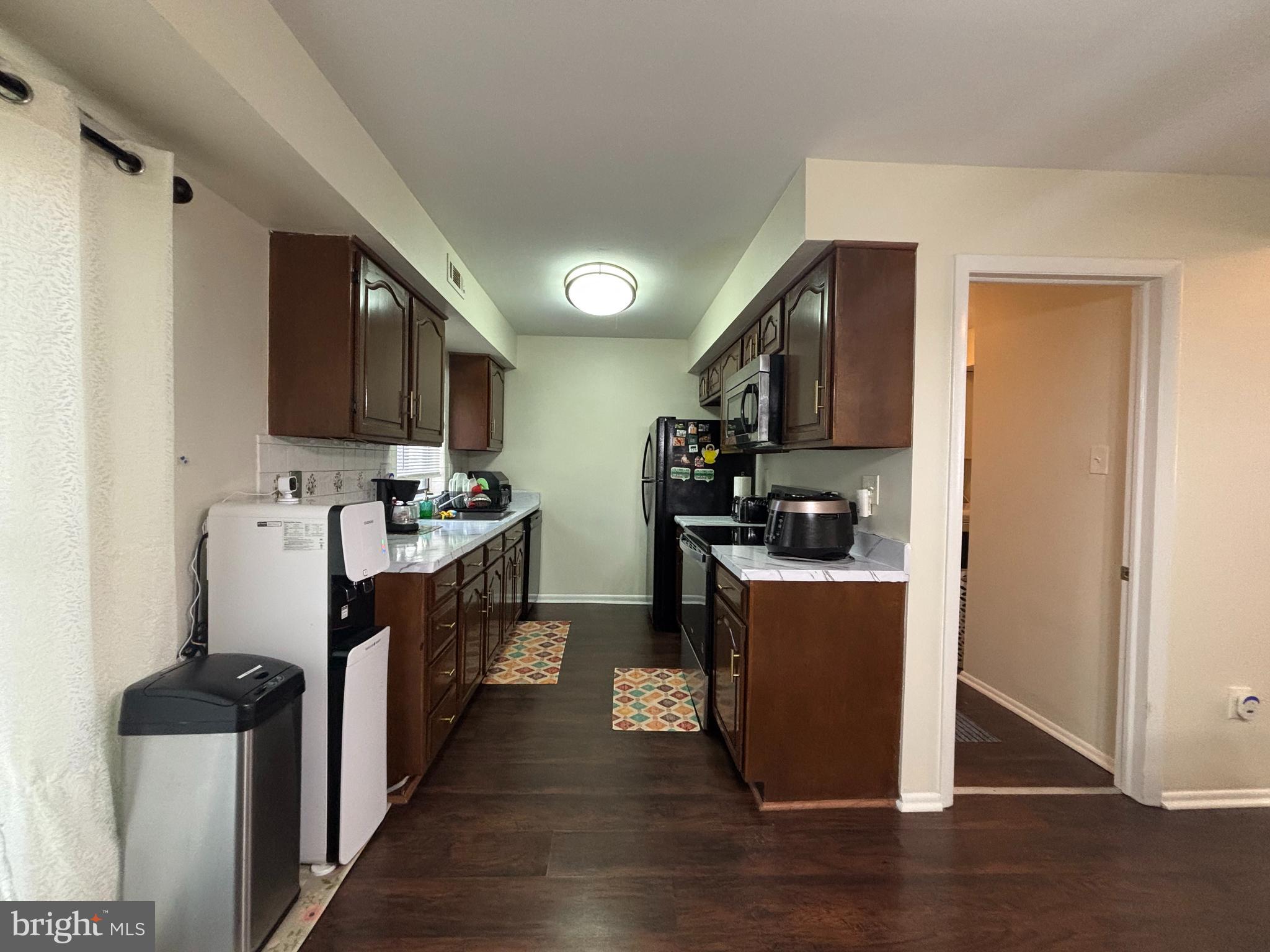 35 Harwood Lane Clementon, NJ 08021 - Photo 5 of 24 a kitchen with stainless steel appliances kitchen island granite countertop a stove top oven a sink a refrigerator white cabinets and wooden floor