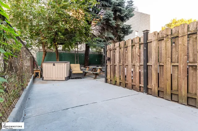 a view of a street with a large tree