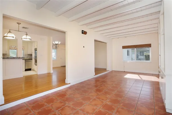 a view of a hallway with wooden floor and a large window