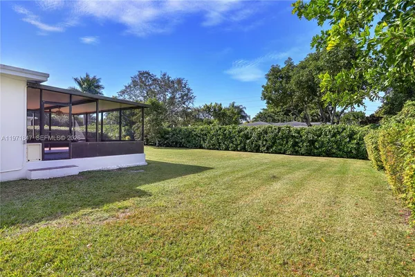 a front view of a house with a yard and a garage