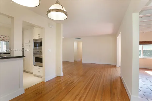 a view of a kitchen cabinets and wooden floor