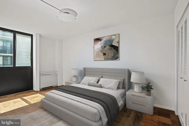 a bedroom with a bed and a painting on the wall