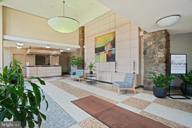 a lobby with furniture and a potted plant