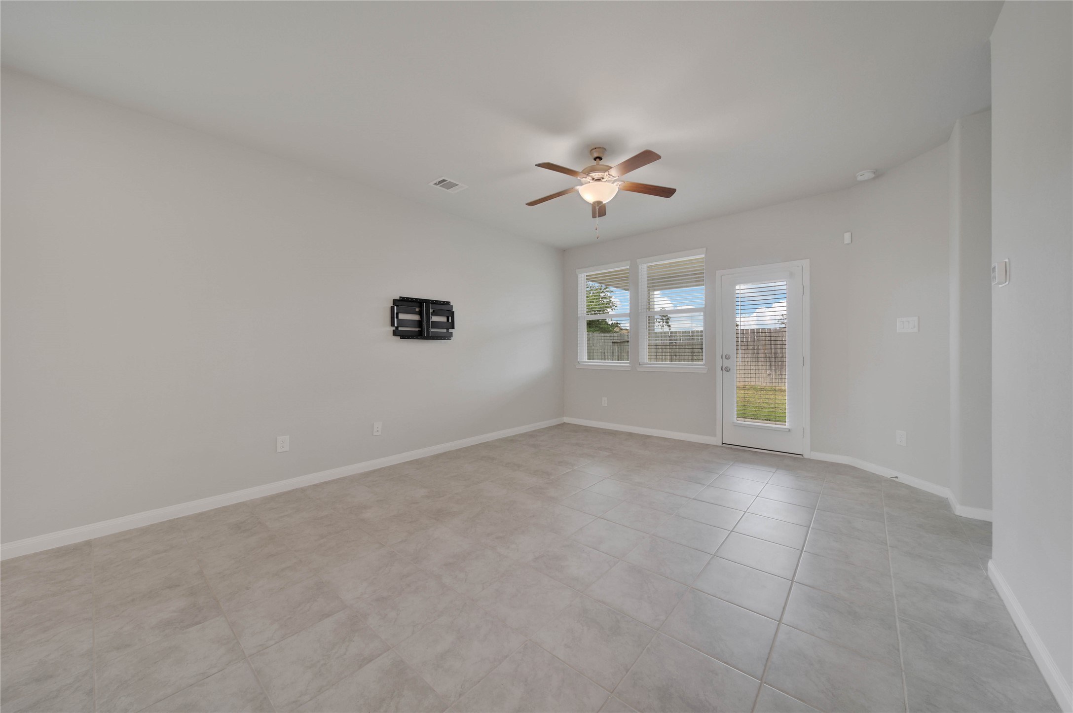 7080 Silverleaf Oak Street Conroe, TX 77304 - Photo 9 of 35 Gather in the inviting family room for your favorite TV show or movie. The living area overlooks the covered patio.
