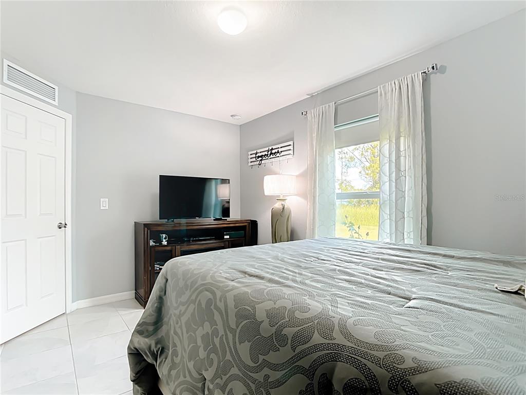 2713 Embassy Road North Port, FL 34291 - Photo 11 of 30 a bedroom with a bed and a flat screen tv