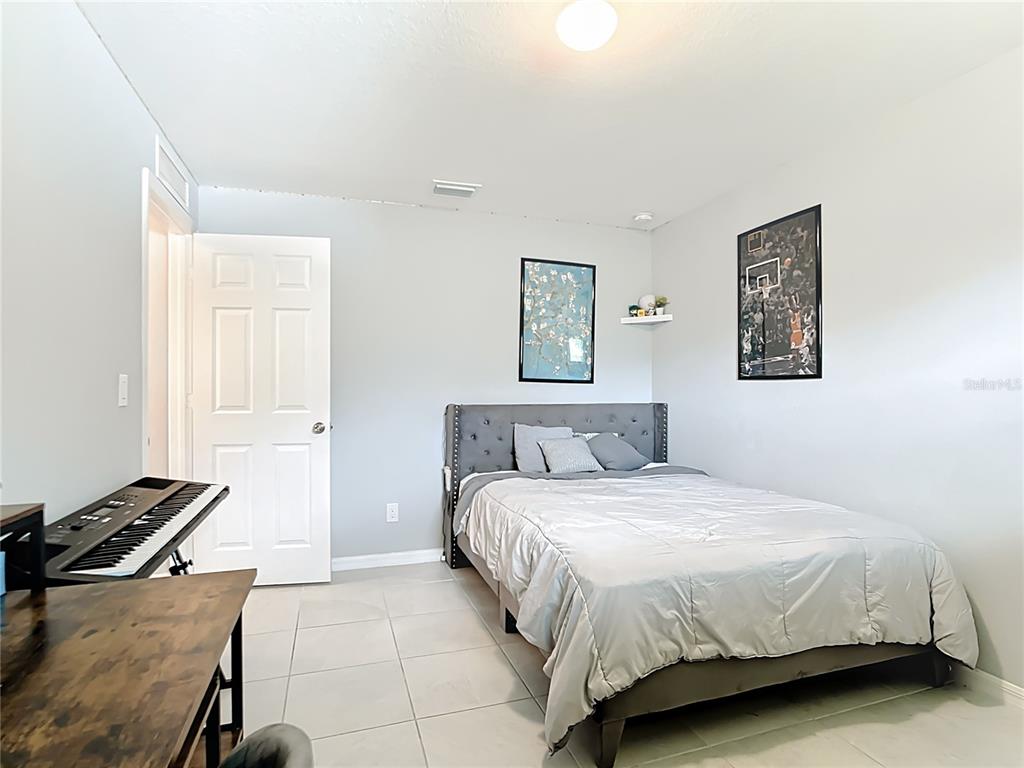 2713 Embassy Road North Port, FL 34291 - Photo 18 of 30 a bedroom with a bed and a window