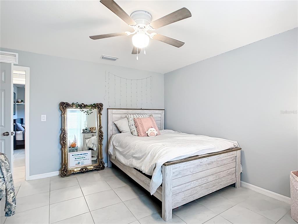 2713 Embassy Road North Port, FL 34291 - Photo 19 of 30 a bedroom with a bed and a ceiling fan