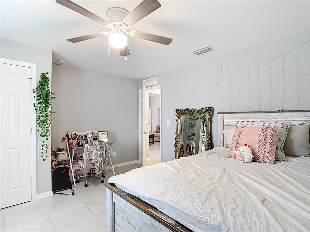 2713 Embassy Road North Port, FL 34291 - Photo 20 of 30 a bedroom with a bed and ceiling fan