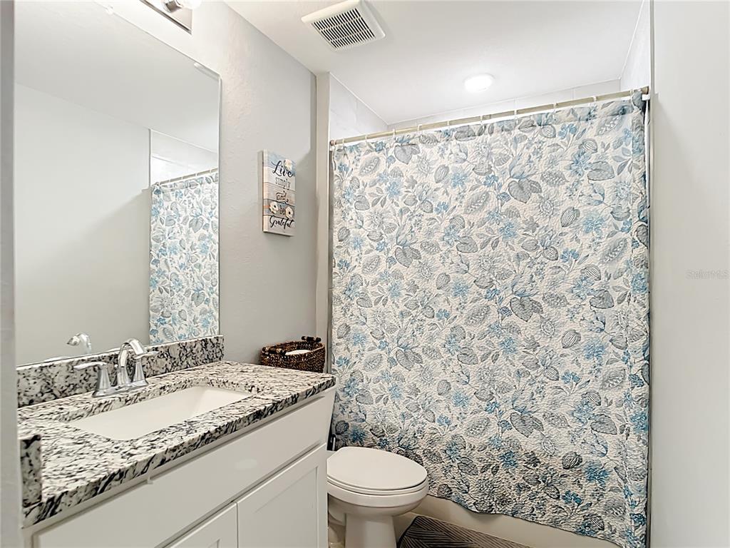 2713 Embassy Road North Port, FL 34291 - Photo 21 of 30 a bathroom with a granite countertop sink toilet and shower