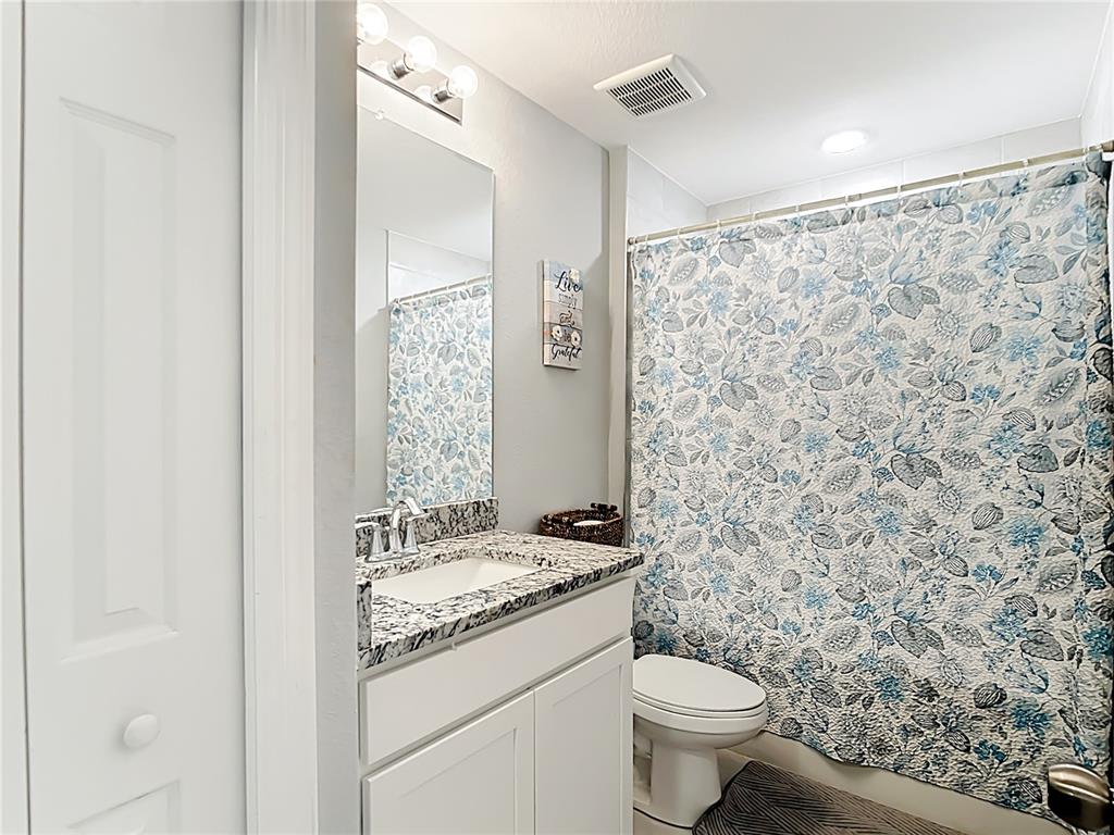 2713 Embassy Road North Port, FL 34291 - Photo 22 of 30 a bathroom with a granite countertop sink a toilet and a mirror