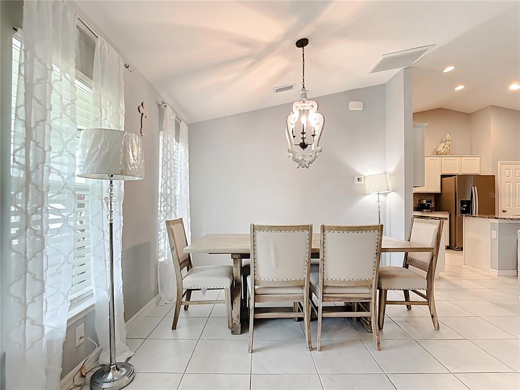 2713 Embassy Road North Port, FL 34291 - Photo 4 of 30 a view of a dining room with furniture and chandelier