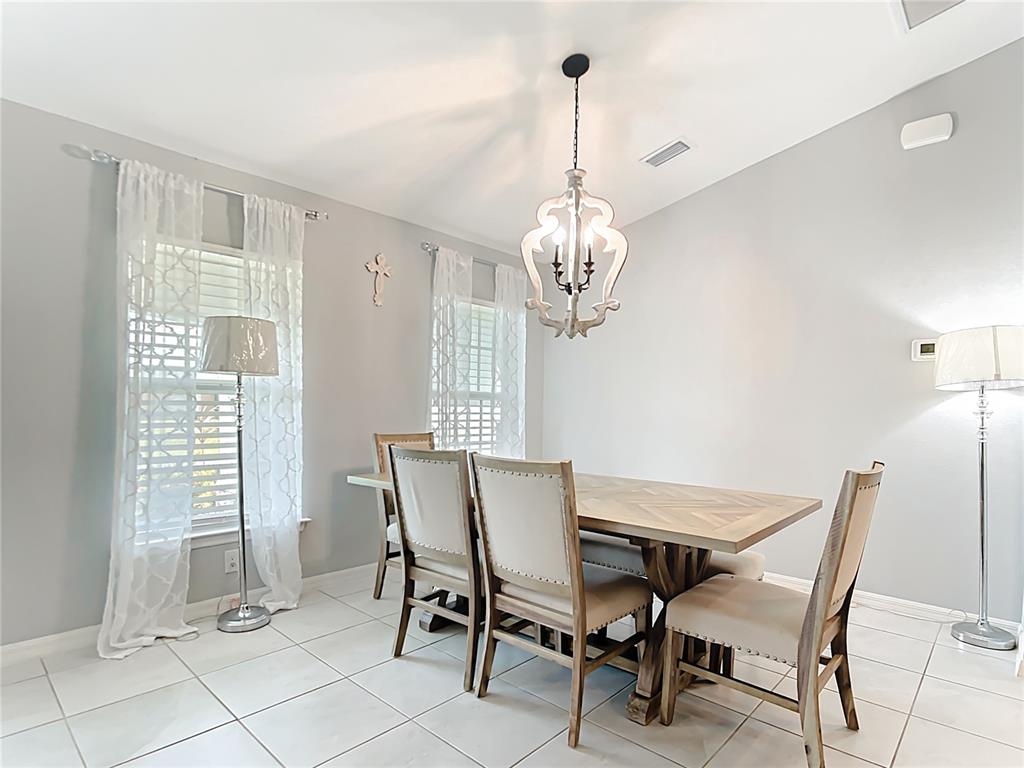 2713 Embassy Road North Port, FL 34291 - Photo 5 of 30 a view of a dining room with furniture wooden floor and chandelier