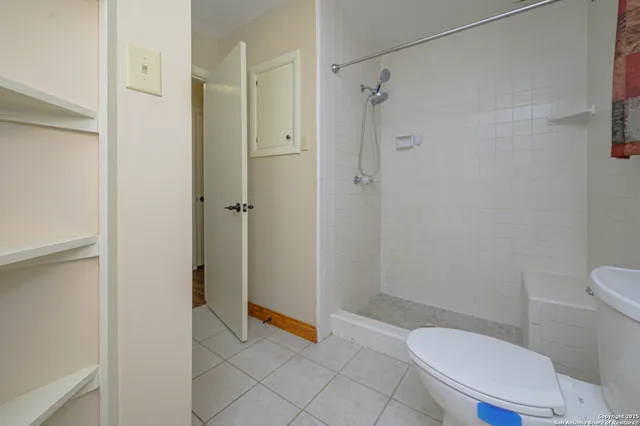 a bathroom with a toilet and a shower