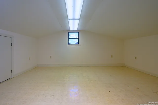 an empty room with a empty space and windows