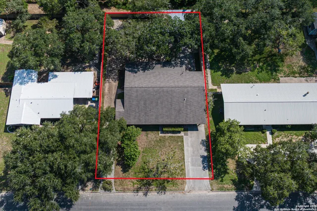 a view of empty room with wooden floor and window