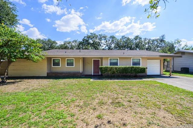 a backyard of a house with table and chairs