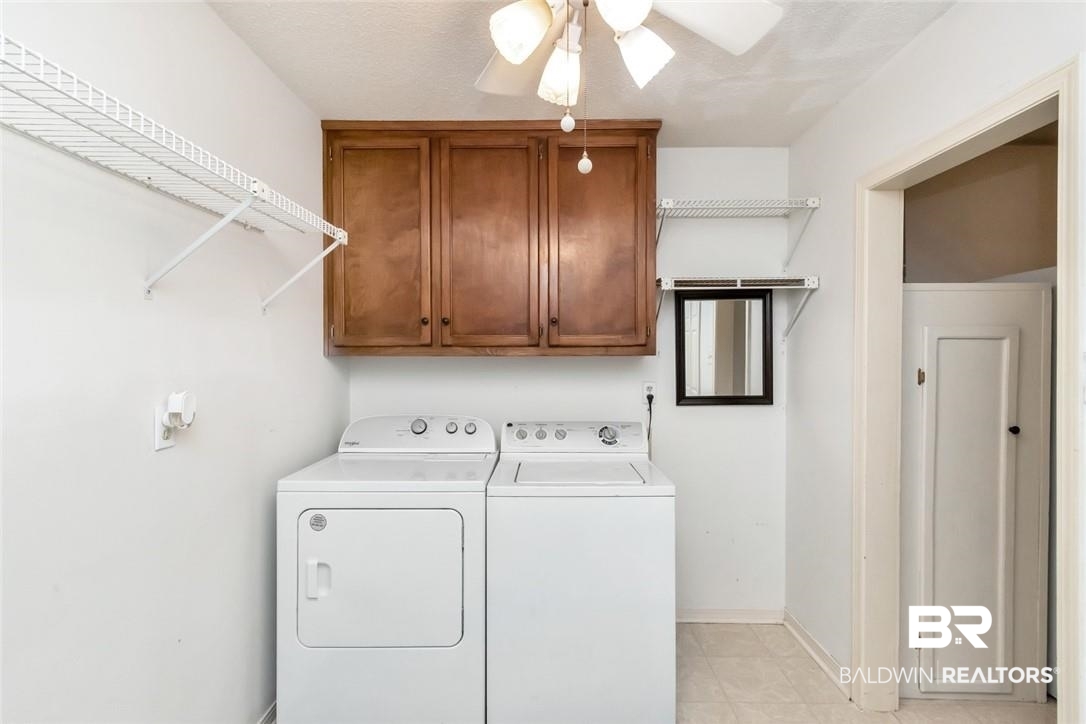 6601 Conde Court Mobile, AL 36695 - Photo 25 of 30 Laundry room with ceiling fan, cabinets, and washer and clothes dryer