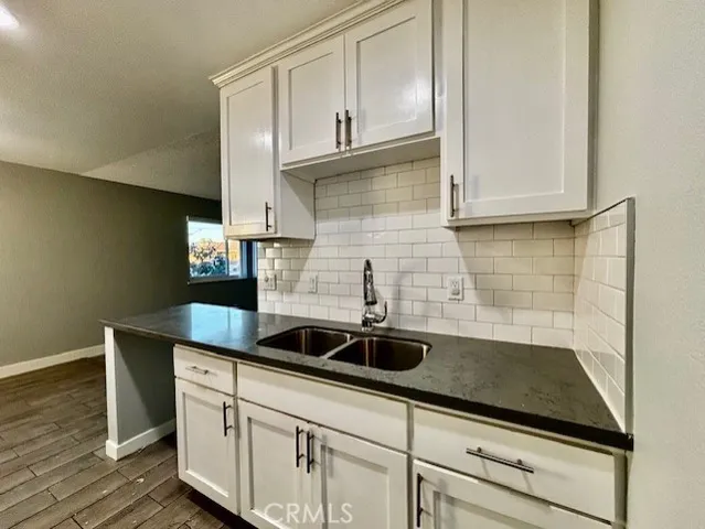 a kitchen with stainless steel appliances a sink a stove and cabinets