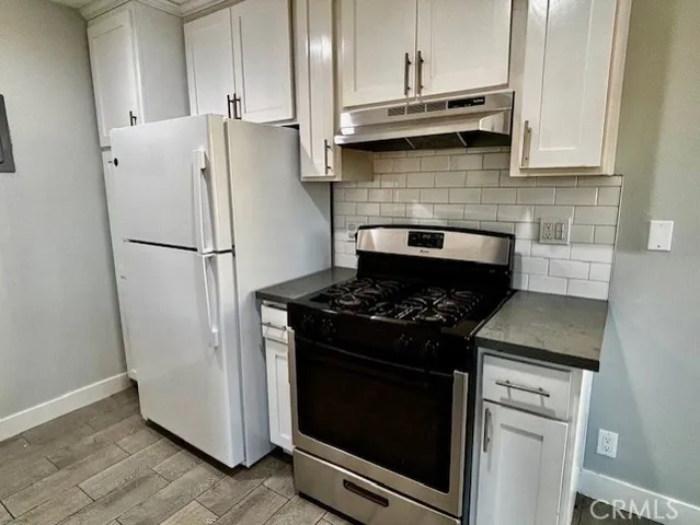 a kitchen with appliances and cabinets