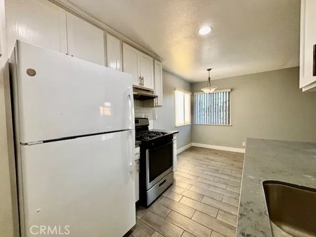 a white refrigerator freezer sitting in a kitchen
