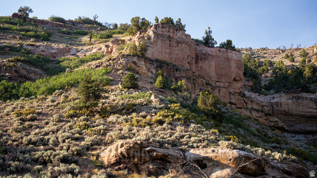 7500 Spring Canyon Road Helper, UT 84526 - Photo 58 of 64 Rocky hillside with natural rock formations, scattered evergreen trees, and low-growing sagebrush