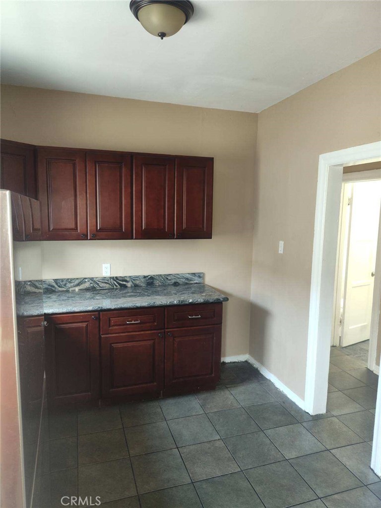 1411 Walnut Avenue Long Beach, CA 90813 - Photo 3 of 7 a kitchen with granite countertop a sink a stove and cabinets