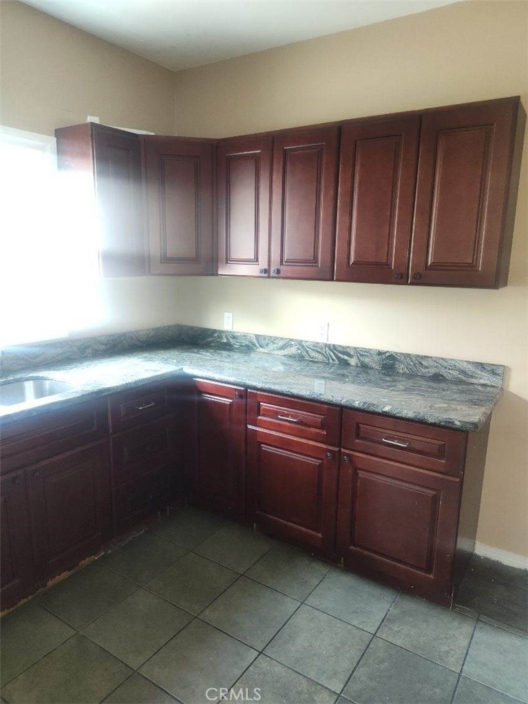 1411 Walnut Avenue Long Beach, CA 90813 - Photo 4 of 7 a kitchen with granite countertop a sink a stove and cabinets