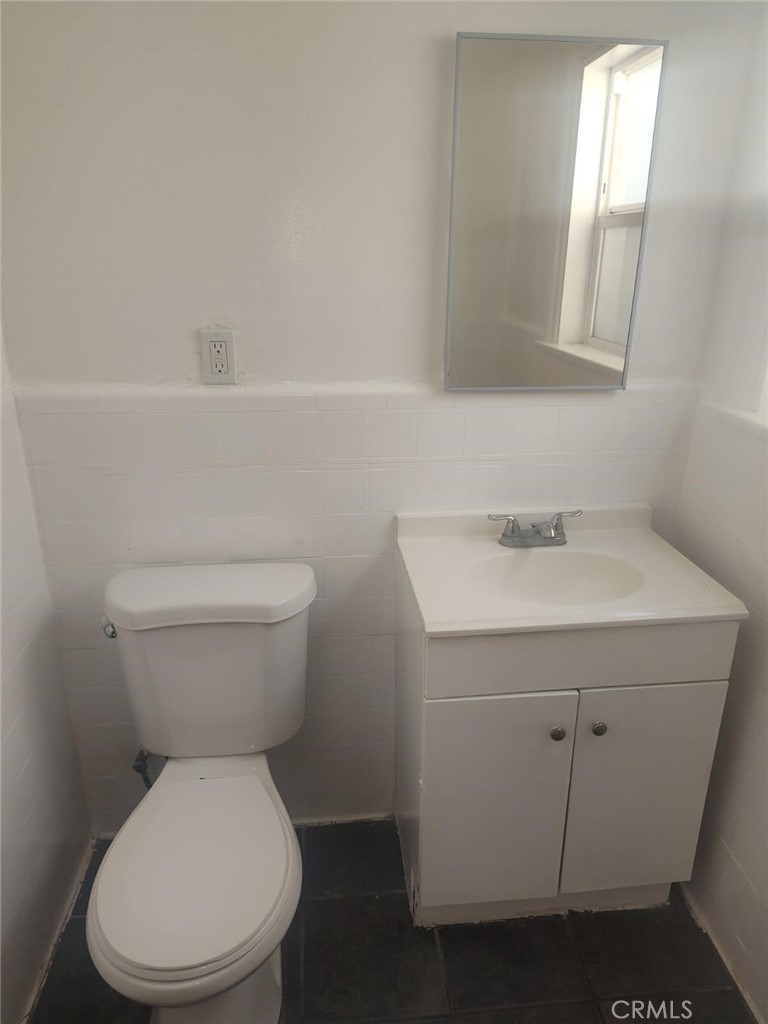 1411 Walnut Avenue Long Beach, CA 90813 - Photo 6 of 7 a white toilet sitting next to a bathroom sink