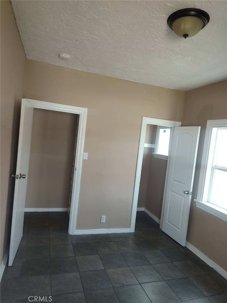 1411 Walnut Avenue Long Beach, CA 90813 - Photo 7 of 7 an empty room with windows and refrigerator