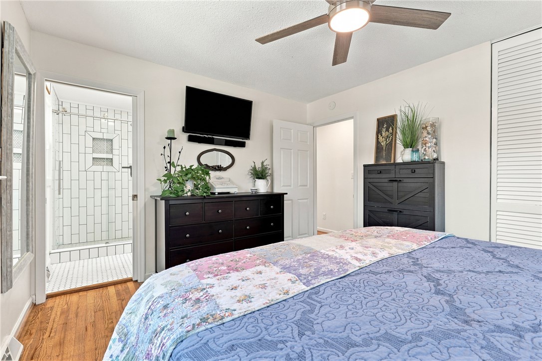 204 Sylvia Road Easley, SC 29642 - Photo 18 of 36 Comfortable bedroom with wood flooring and a modern ceiling fan, offering direct access to an adjoining bathroom.