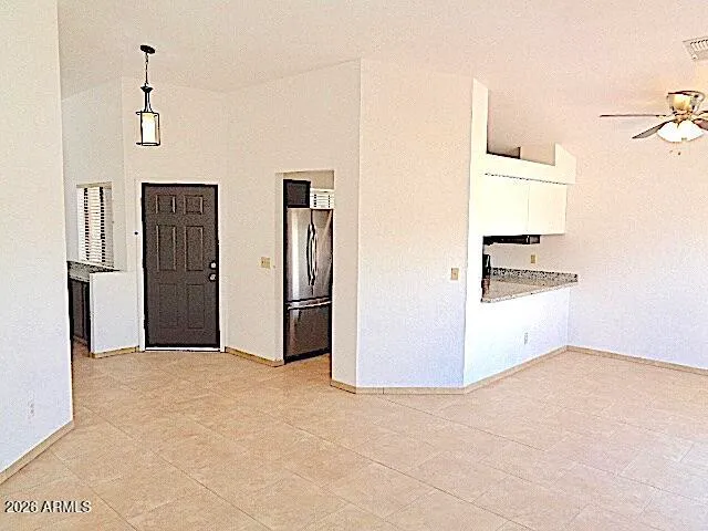a view of a kitchen with a refrigerator and a sink