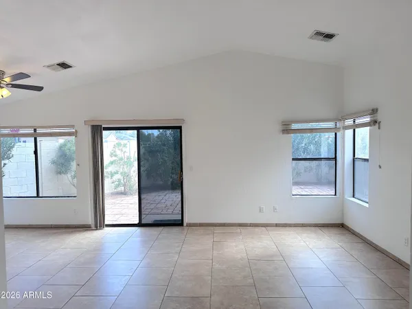 an empty room with windows and closet