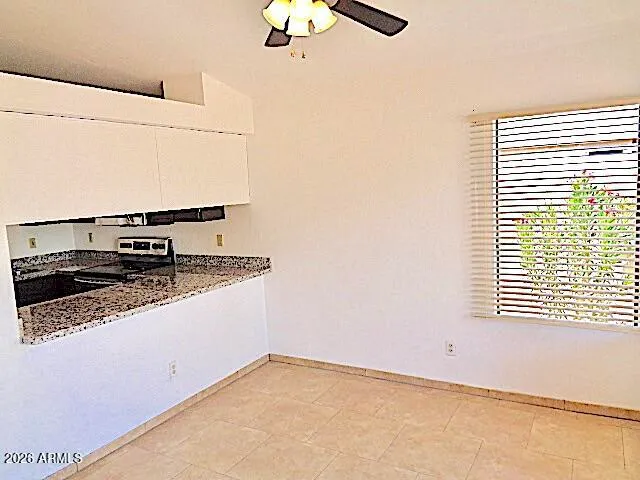 a kitchen with a stove and a window
