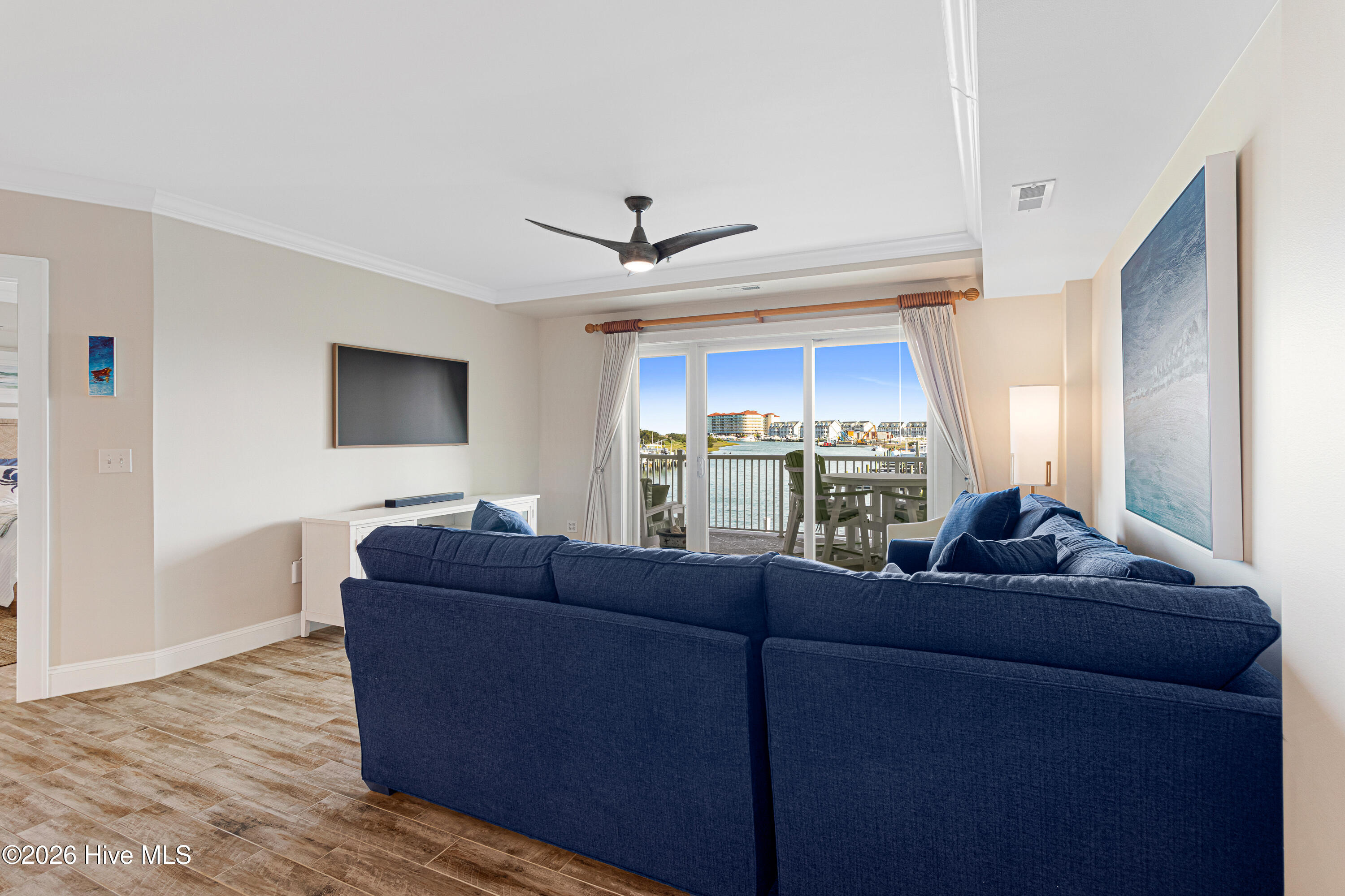 212 Old Causeway Road, Unit 107 & B13 SLIP Beaufort, NC 28516 - Photo 4 of 49 Living room with covered balcony access