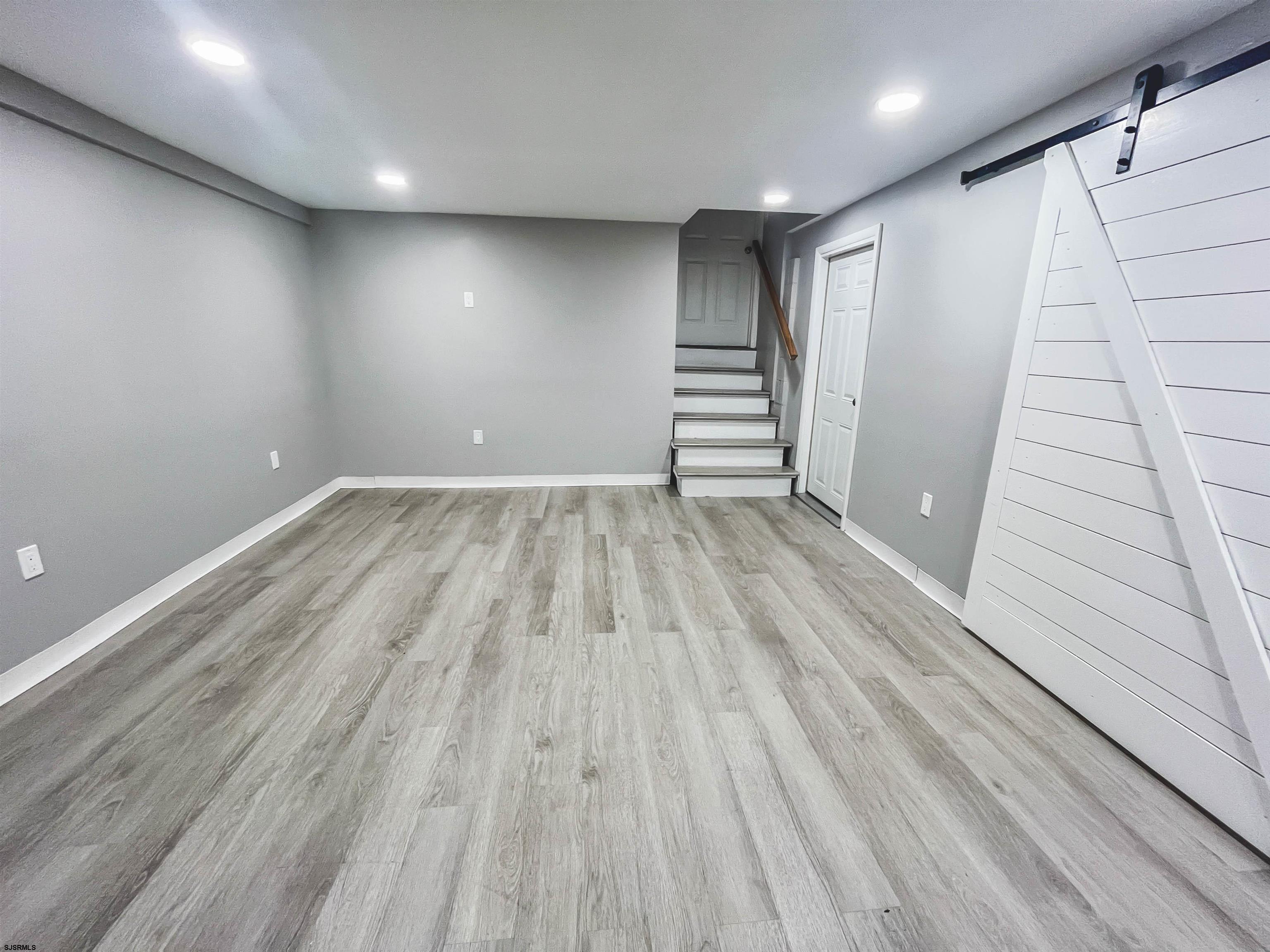 518 Delaware Avenue Absecon, NJ 08201 - Photo 27 of 38 an empty room with wooden floor and windows