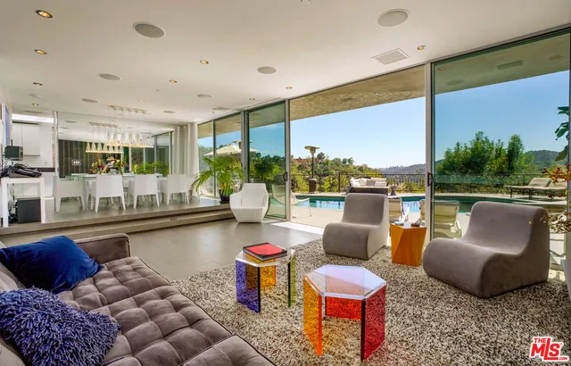 a living room with furniture and a floor to ceiling window