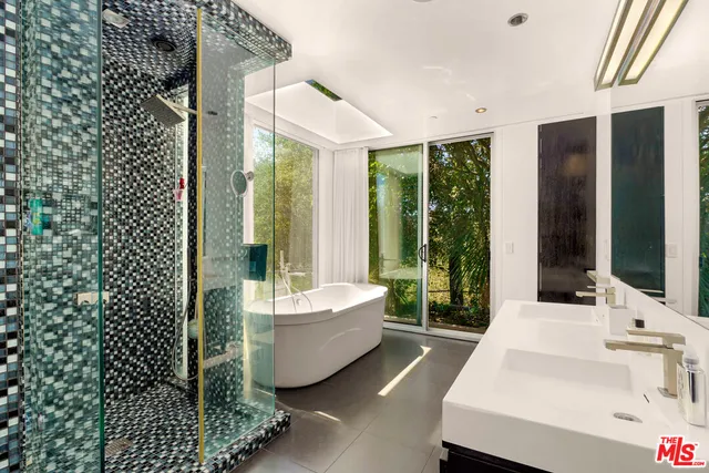 a spacious bathroom with a bathtub and sink