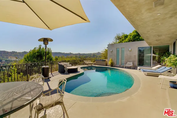a view of a swimming pool with a patio